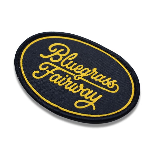 Oval shaped black and gold custom woven patch